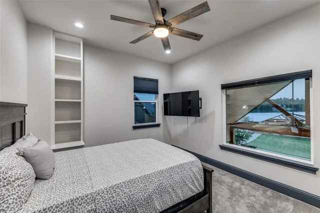 a bedroom with a large bed and a tv