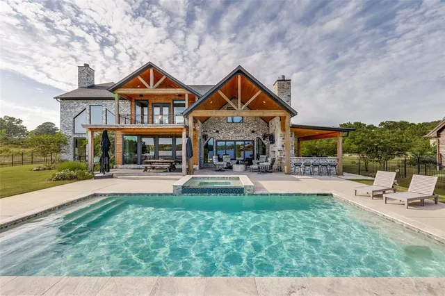 a view of a house with a yard and a large tree
