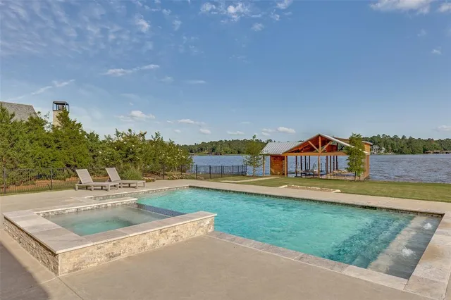 a front view of a house with swimming pool and porch