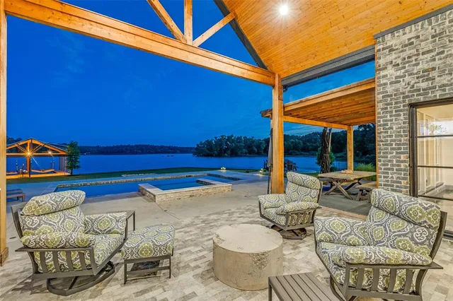 an aerial view of a house with swimming pool and garden