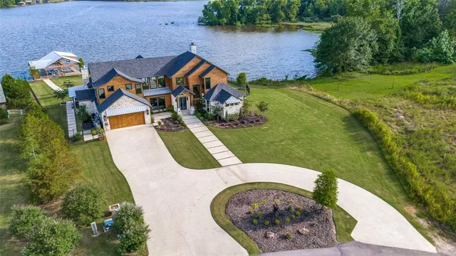 an aerial view of a house with outdoor space pool seating area and fire pit