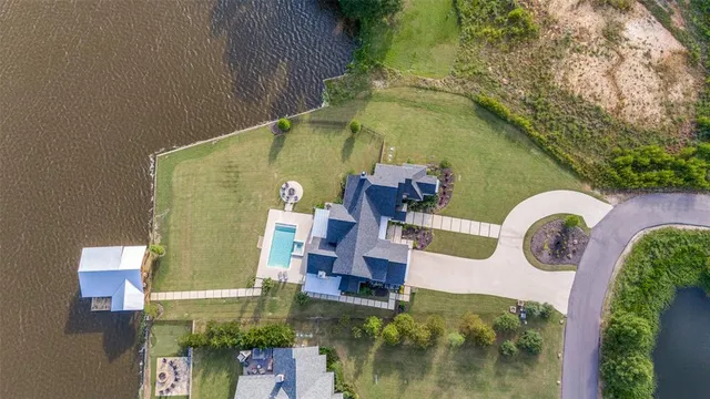 a view of a pool with a table and chairs