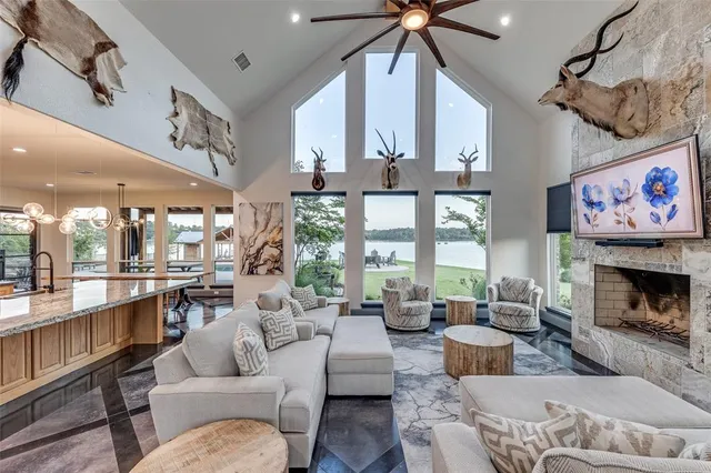 a living room with furniture large window and a fireplace