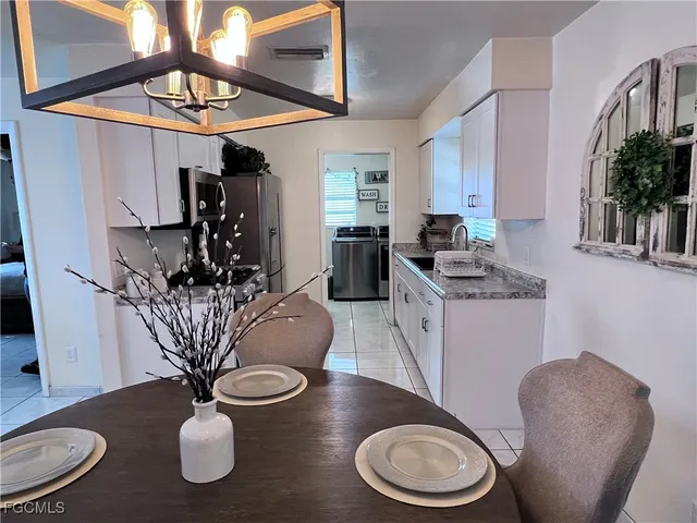 a dining room with furniture potted plants and wooden floor