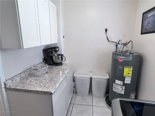 a bathroom with a granite countertop sink and a toilet