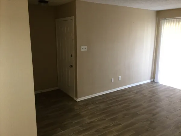 an empty room with wooden floor