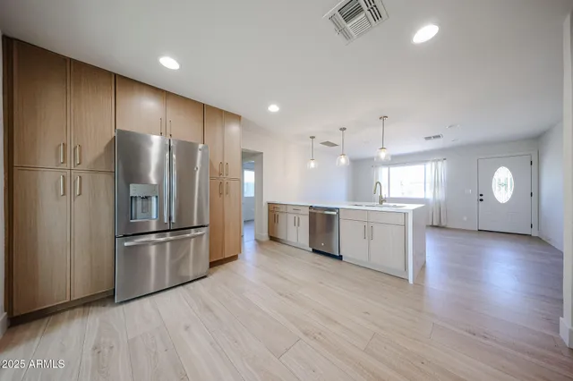 a view of a kitchen with a refrigerator and a sink