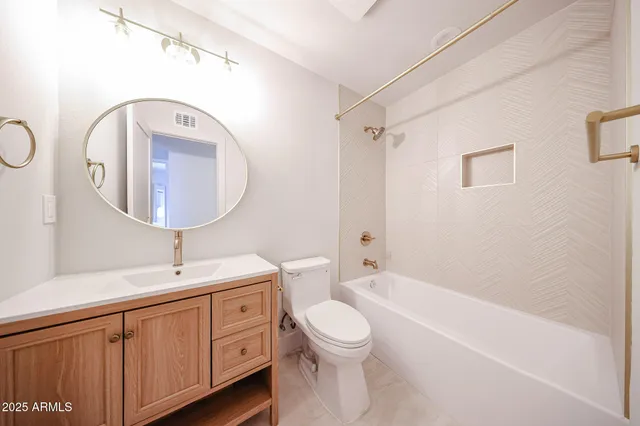 a bathroom with a double vanity sink mirror and toilet