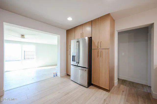 a metallic refrigerator freezer sitting in a kitchen