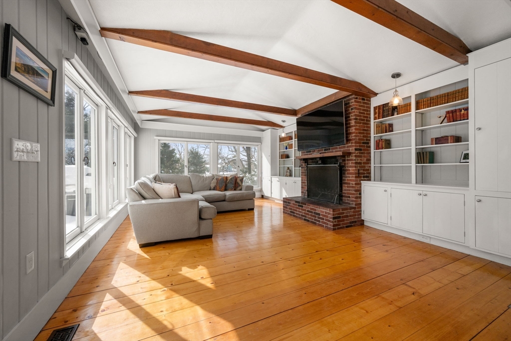 2 Old Sudbury Road Wayland, MA 01778 - Photo 11 of 40 a living room with furniture a flat screen tv and a floor to ceiling window