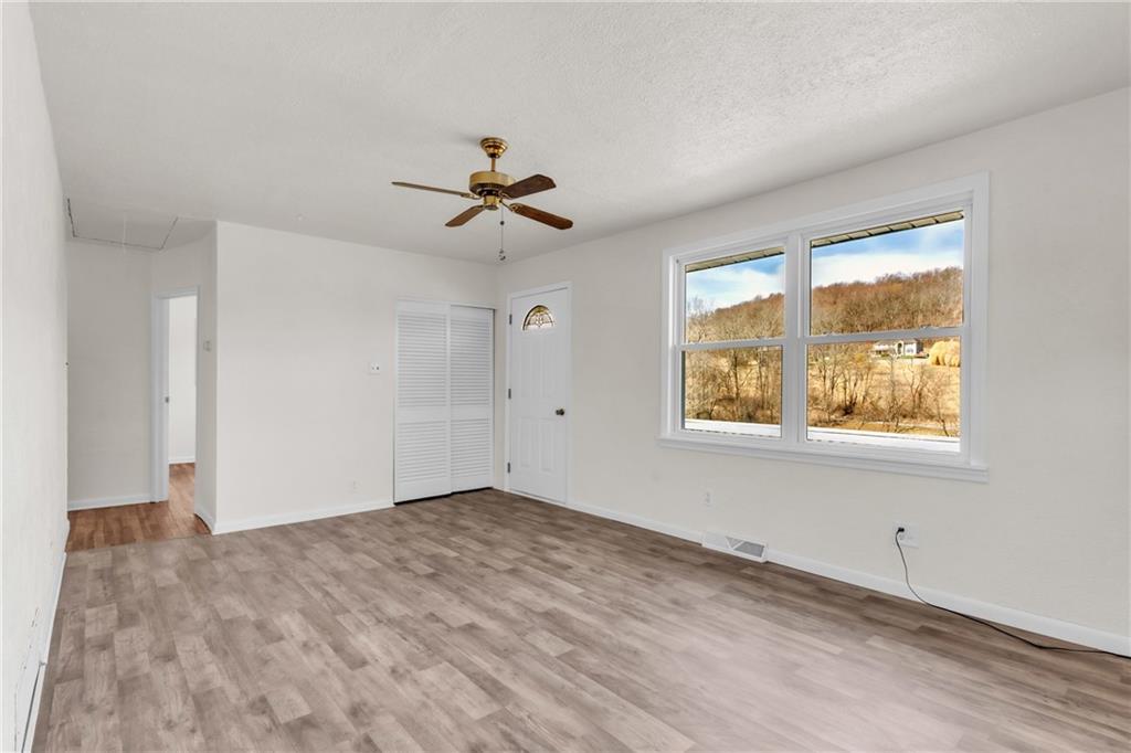 157 Studebaker Road Slippery Rock, PA 16057 - Photo 14 of 34 a view of empty room with wooden floor and fan