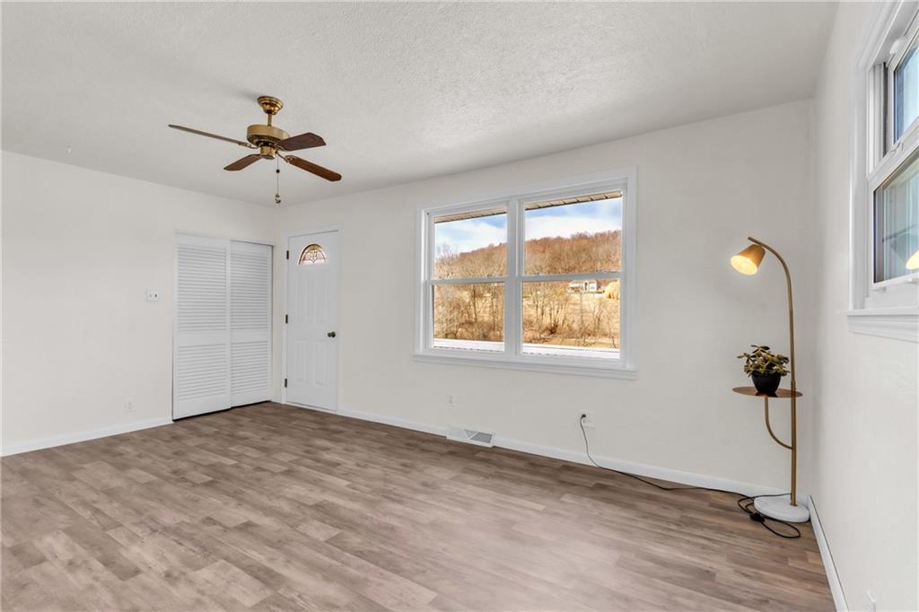 157 Studebaker Road Slippery Rock, PA 16057 - Photo 15 of 34 a view of empty room with wooden floor and fan