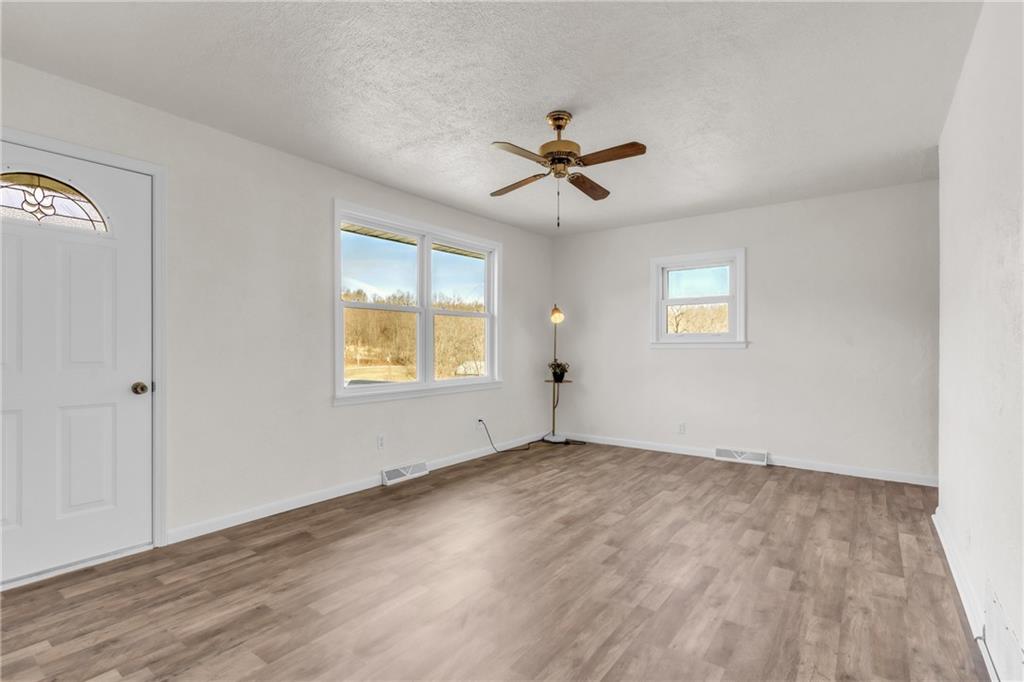157 Studebaker Road Slippery Rock, PA 16057 - Photo 16 of 34 a view of empty room with wooden floor and fan