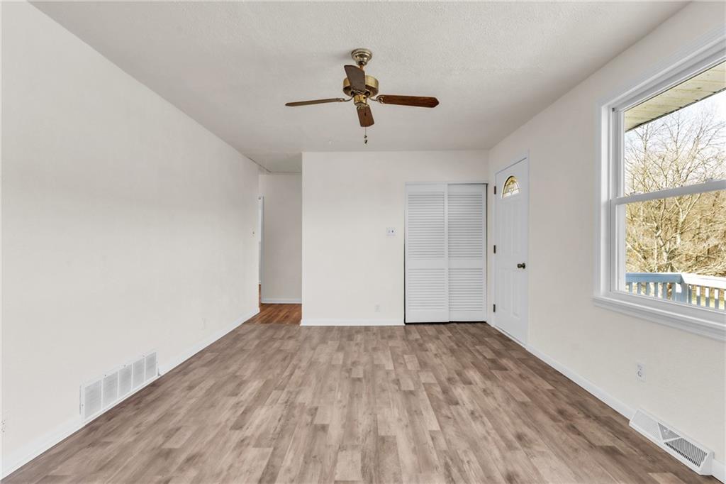 157 Studebaker Road Slippery Rock, PA 16057 - Photo 17 of 34 a view of empty room with wooden floor and fan