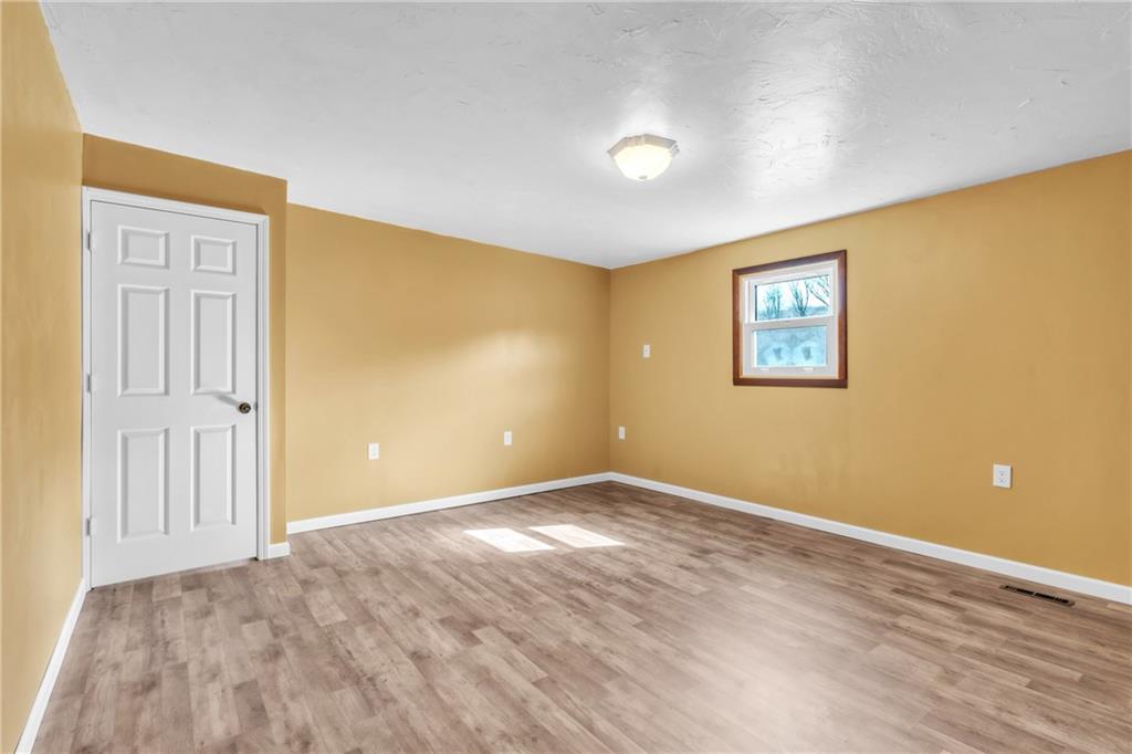 157 Studebaker Road Slippery Rock, PA 16057 - Photo 18 of 34 a view of an empty room with wooden floor and a window