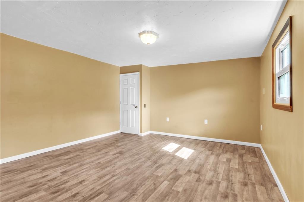 157 Studebaker Road Slippery Rock, PA 16057 - Photo 19 of 34 a view of an empty room with wooden floor and a window