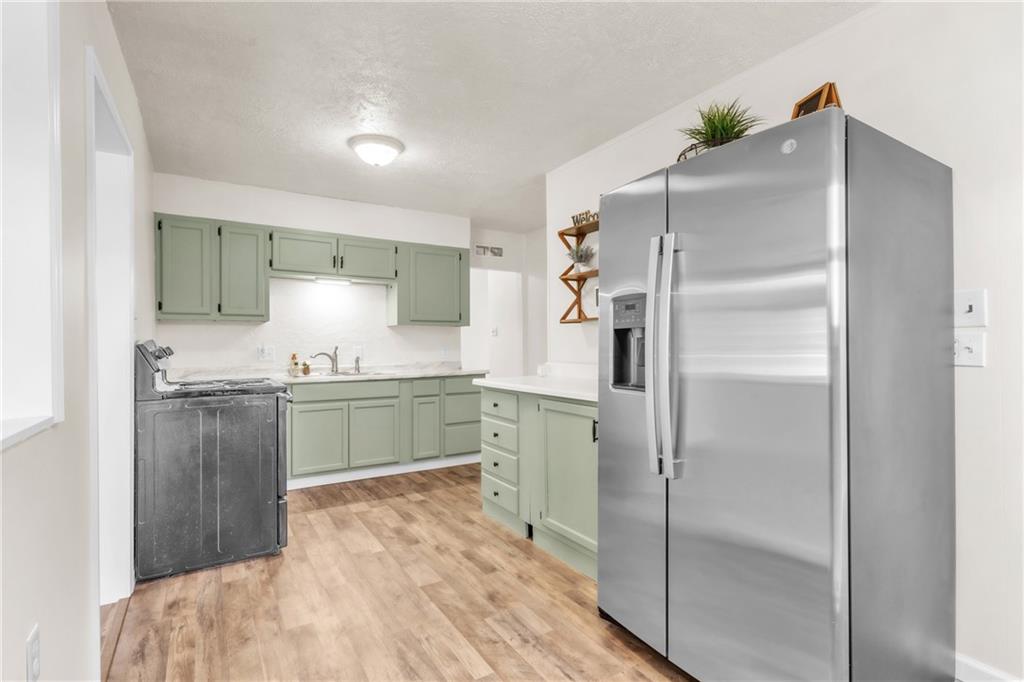 157 Studebaker Road Slippery Rock, PA 16057 - Photo 5 of 34 a kitchen with a refrigerator and a sink