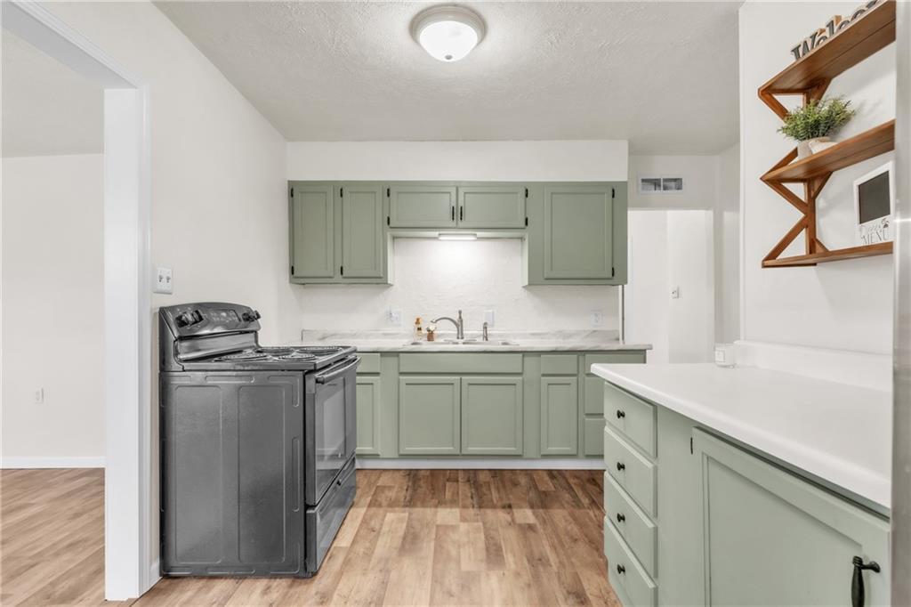 157 Studebaker Road Slippery Rock, PA 16057 - Photo 6 of 34 a kitchen with stainless steel appliances granite countertop a sink stove and refrigerator
