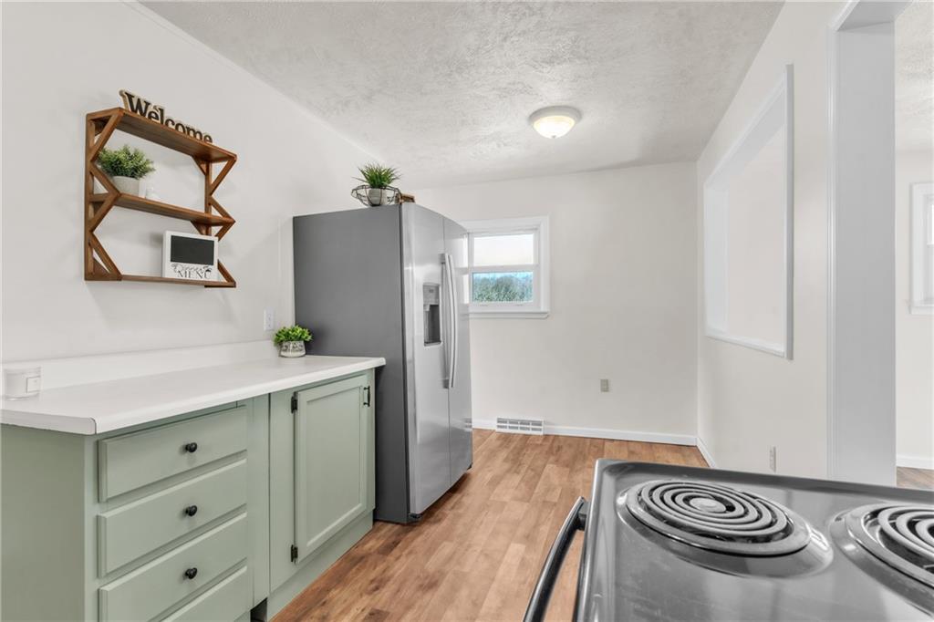 157 Studebaker Road Slippery Rock, PA 16057 - Photo 10 of 34 a kitchen with a refrigerator and a stove