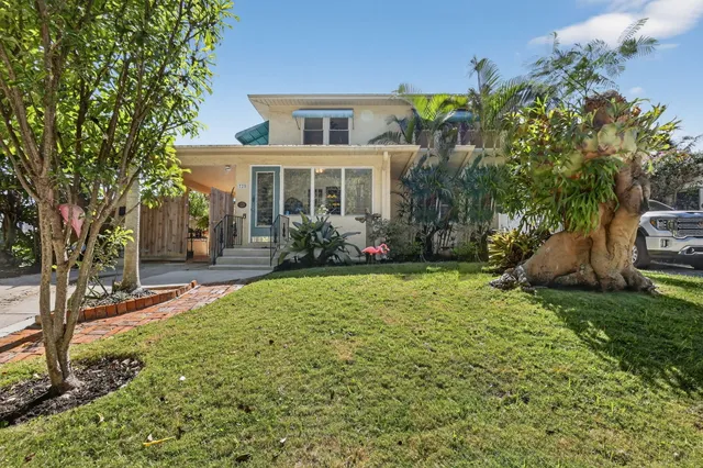 a front view of a house with garden