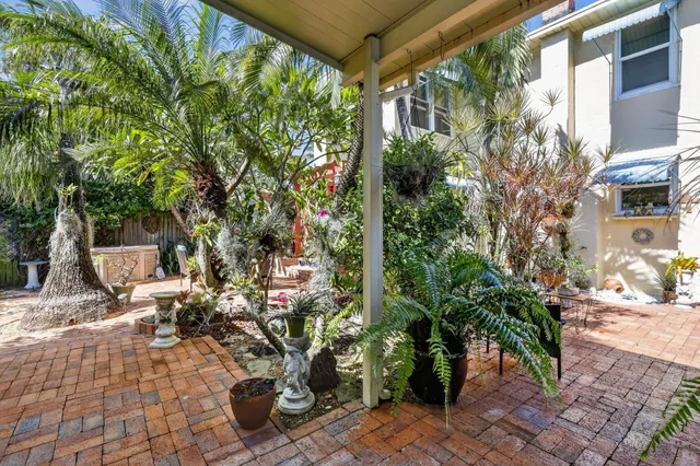a bedroom with a bed and a large mirror on the dresser