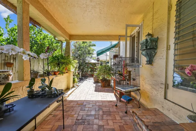 a view of a patio with table and chairs and potted plants