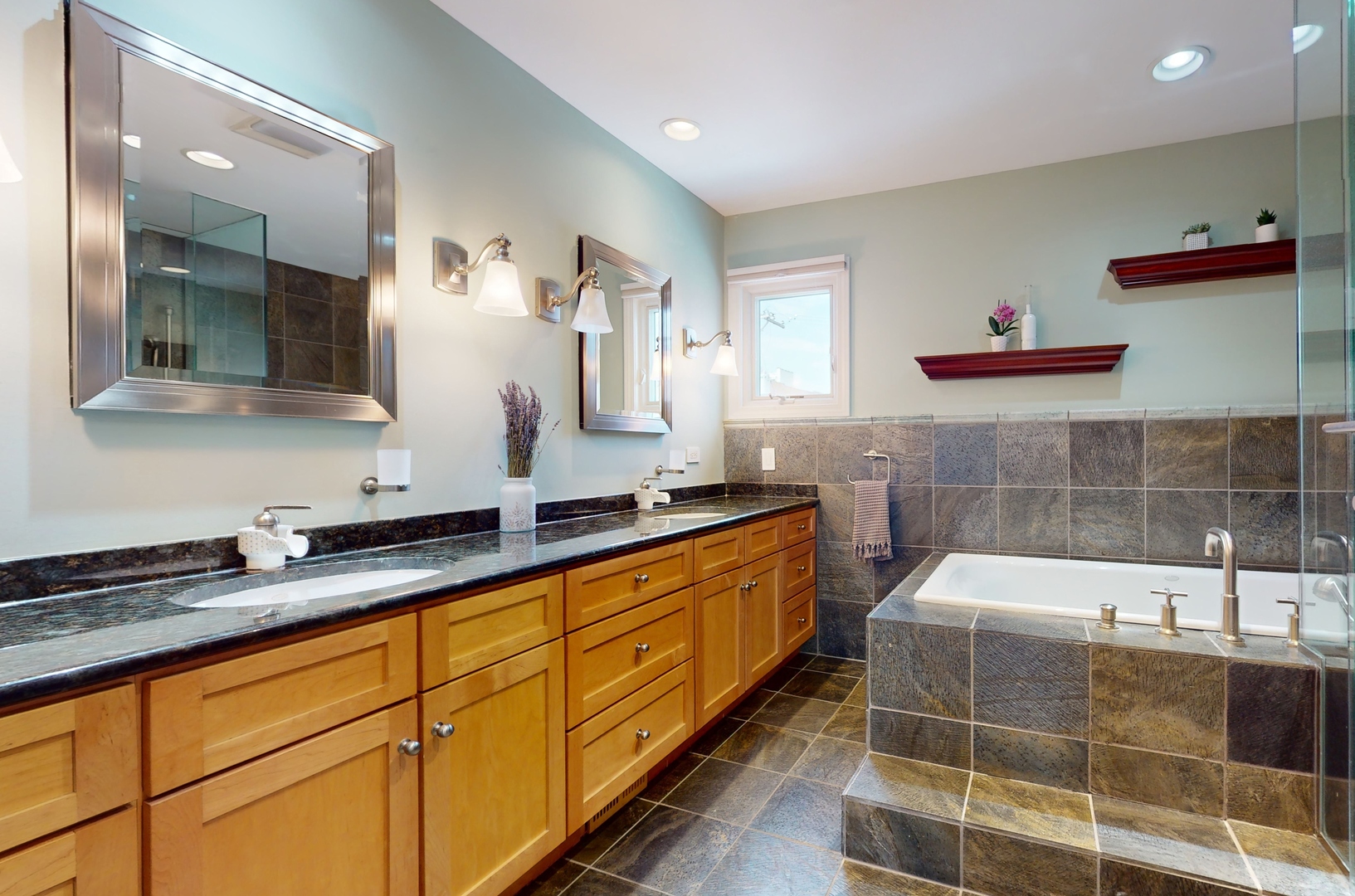 804 South Morgan Street Chicago, IL 60607 - Photo 27 of 32 a bathroom with a double vanity sink a mirror and a bathtub