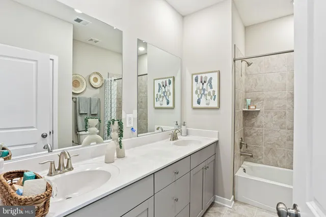 a bathroom with a tub sink and mirror
