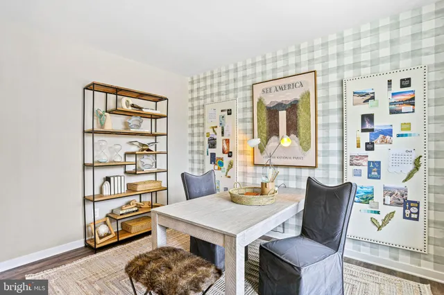 a living room with hard wood furniture and a wooden floor