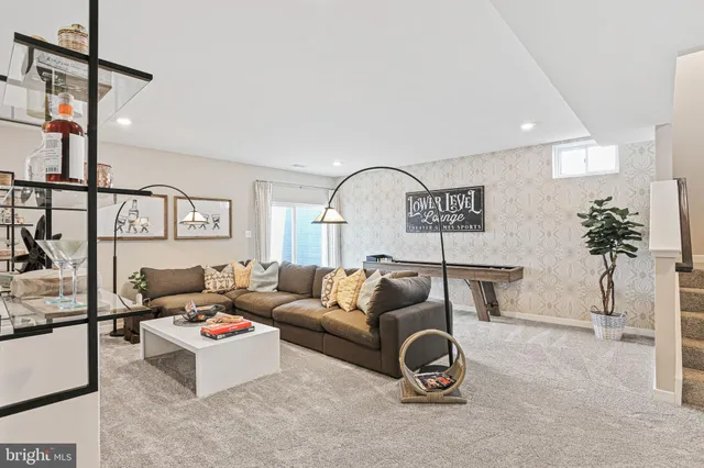 a living room with furniture a rug and a painting