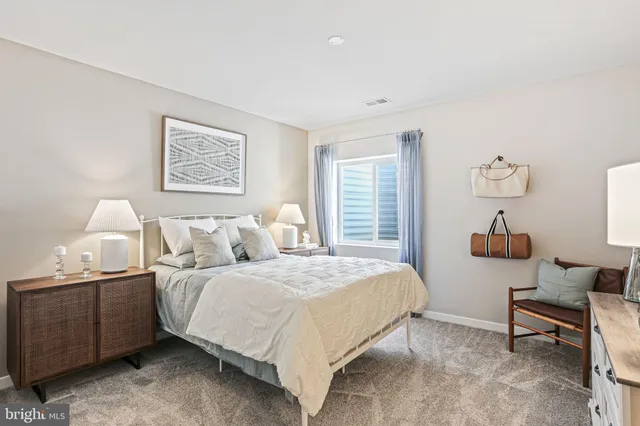 a bedroom with a bed a couch and a window