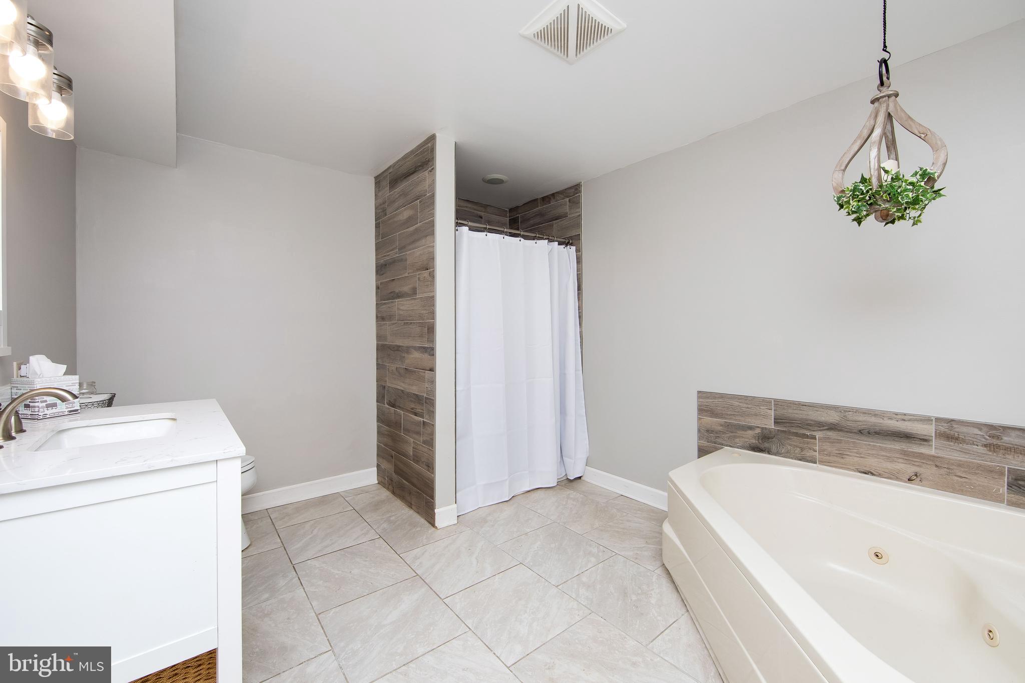 27 Wicklow Drive Tabernacle, NJ 08088 - Photo 27 of 65 a bathroom with a tub sink and toilet