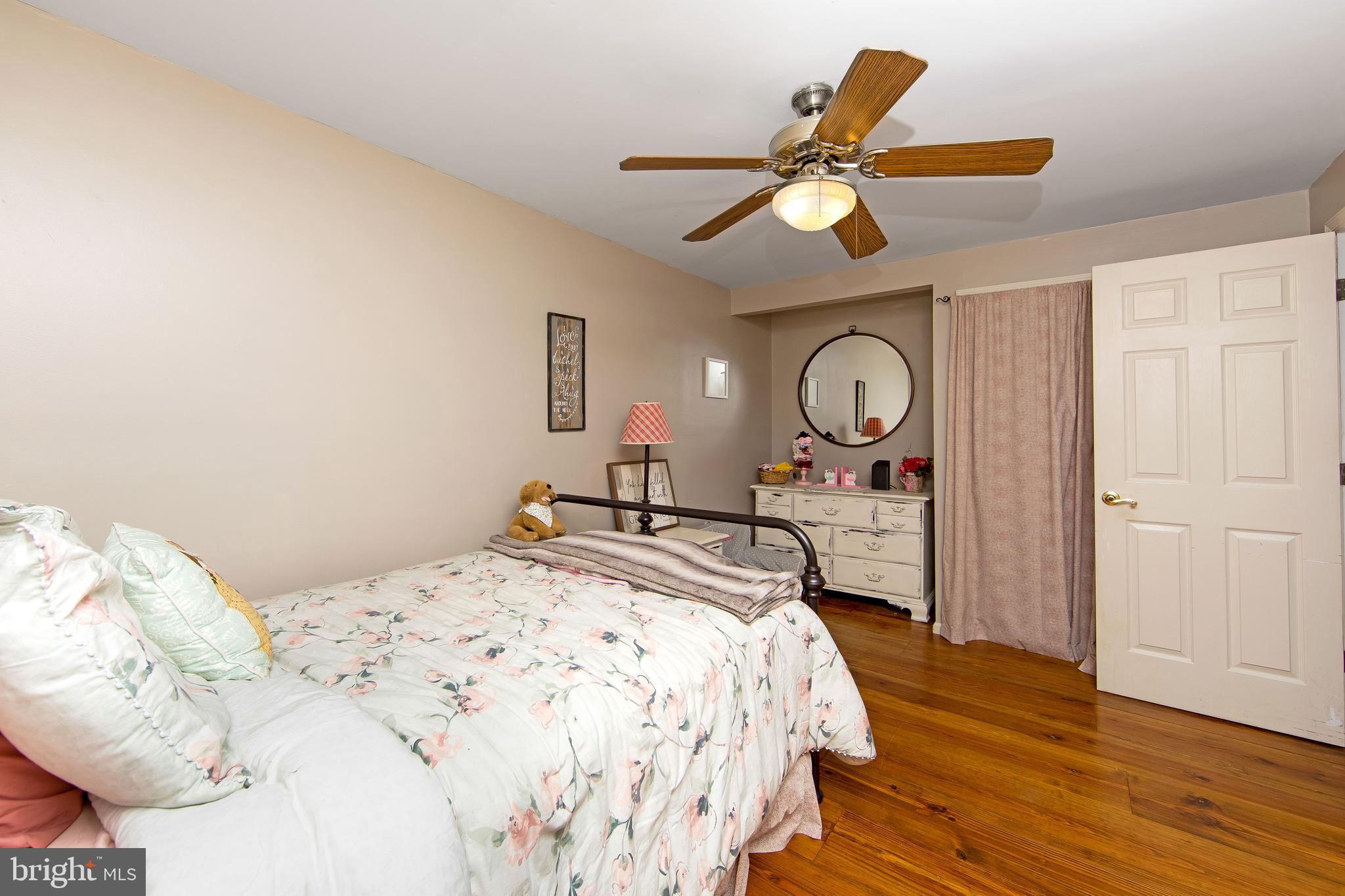 27 Wicklow Drive Tabernacle, NJ 08088 - Photo 29 of 65 a bedroom with a bed mirror on desk and a chandelier