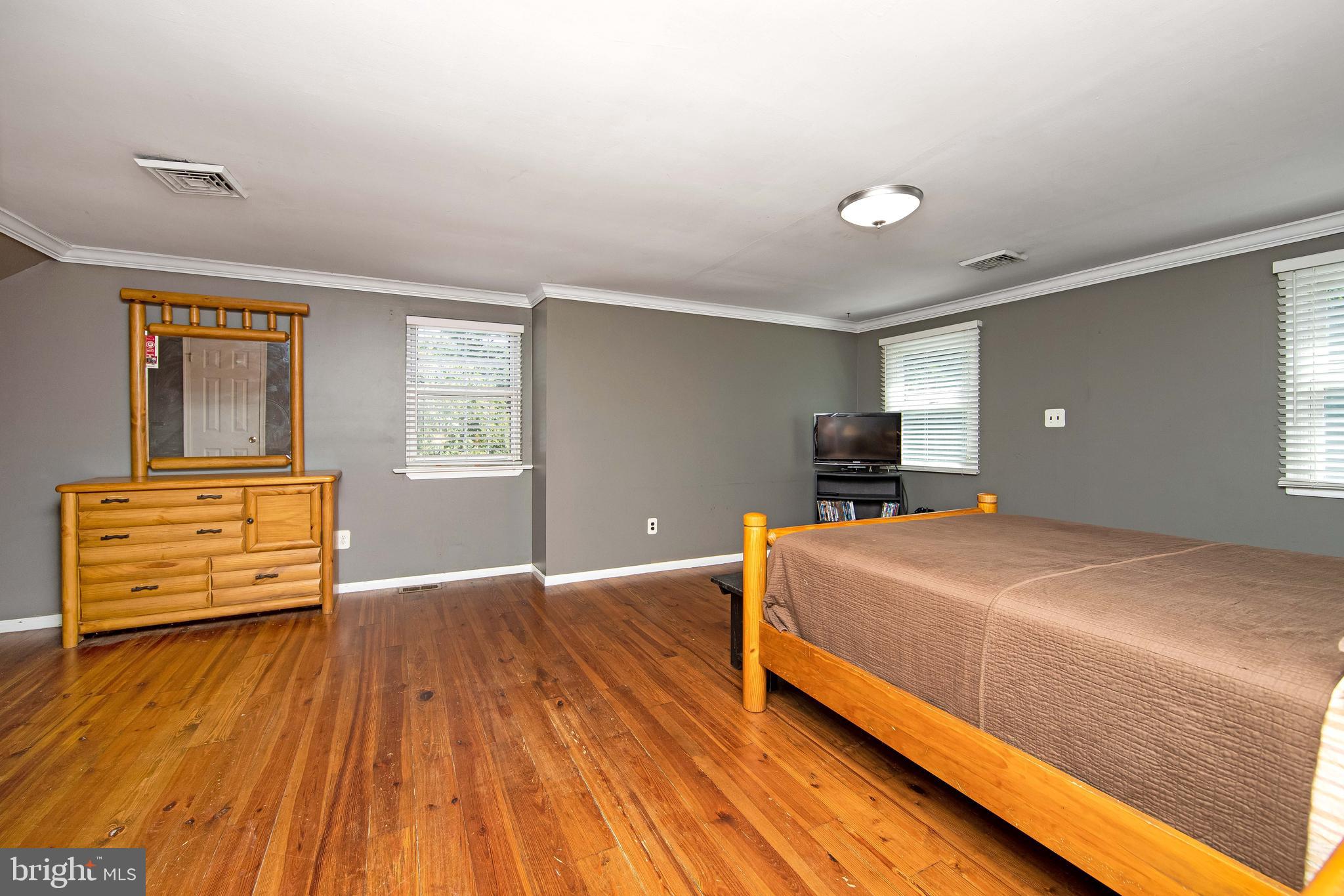 27 Wicklow Drive Tabernacle, NJ 08088 - Photo 30 of 65 a bedroom with a bed and wooden floor