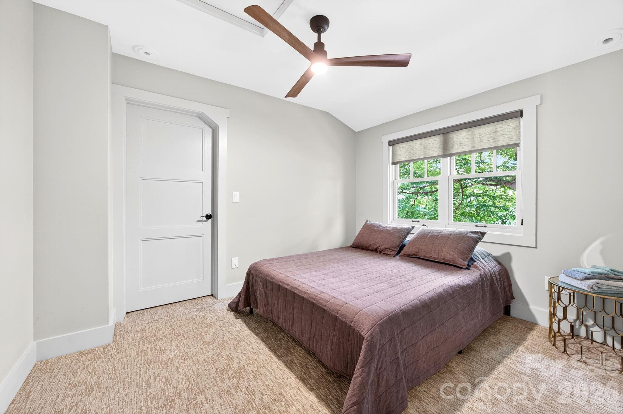 235 Bull Creek Road Asheville, NC 28805 - Photo 22 of 47 a bedroom with a bed and a window
