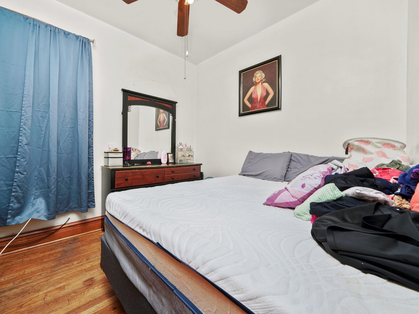 2131 North Springfield Avenue Chicago, IL 60647 - Photo 20 of 30 a bedroom with a bed and a chandelier