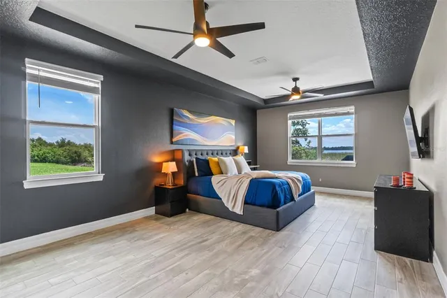 a bedroom with a bed and dresser with window