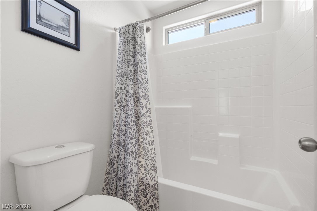 891 Earth Luster Road Las Vegas, NV 89178 - Photo 23 of 48 A well-lit bathroom features a classic shower-tub combination and a conveniently placed window for natural light.