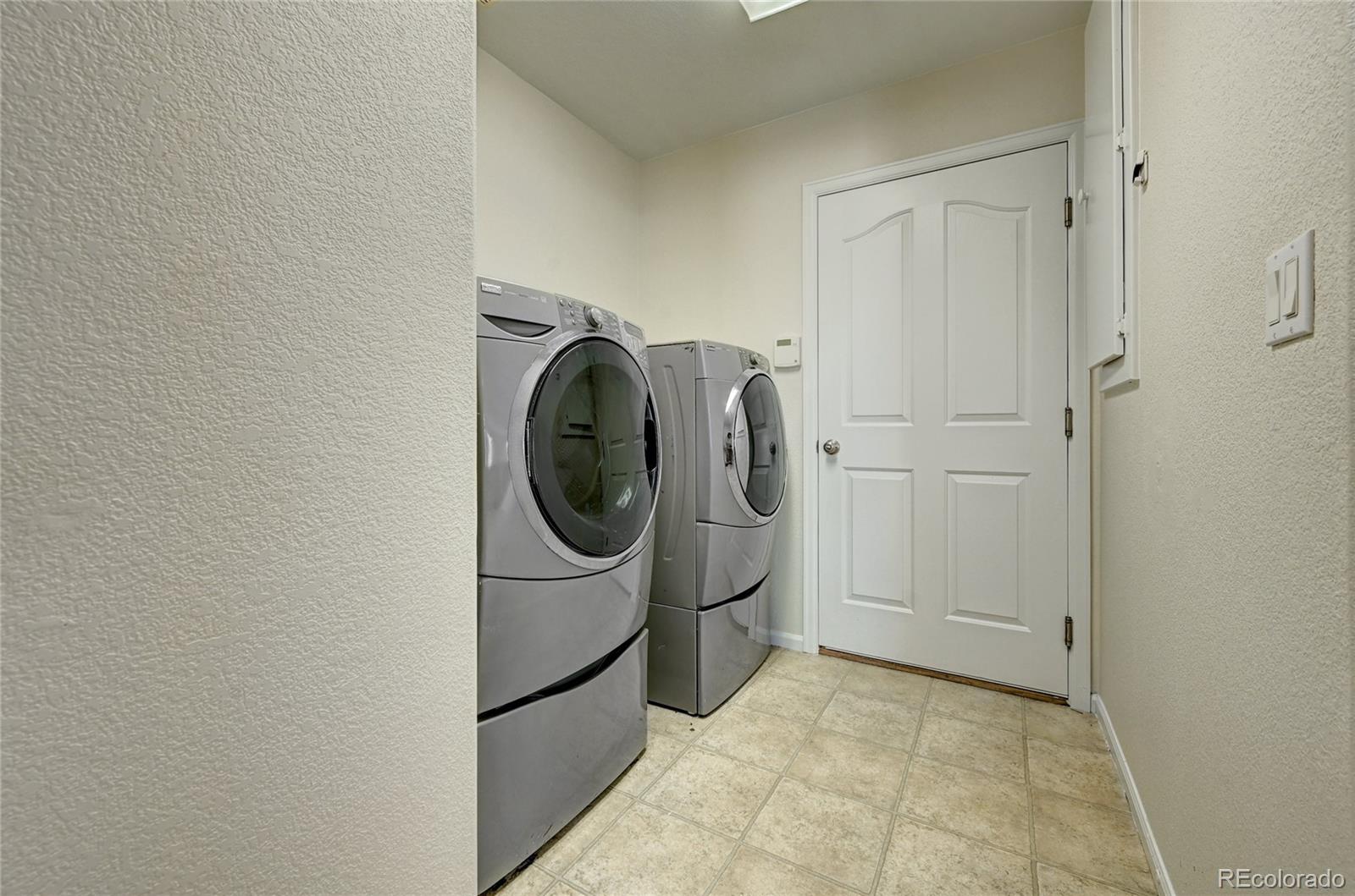 20527 Robins Drive Denver, CO 80249 - Photo 11 of 25 a utility room with dryer and washer