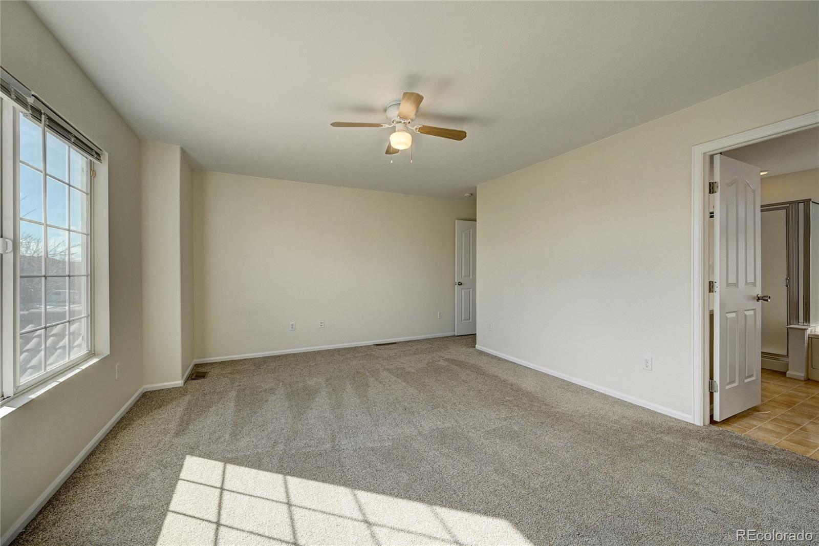 20527 Robins Drive Denver, CO 80249 - Photo 15 of 25 an empty room with windows and fan