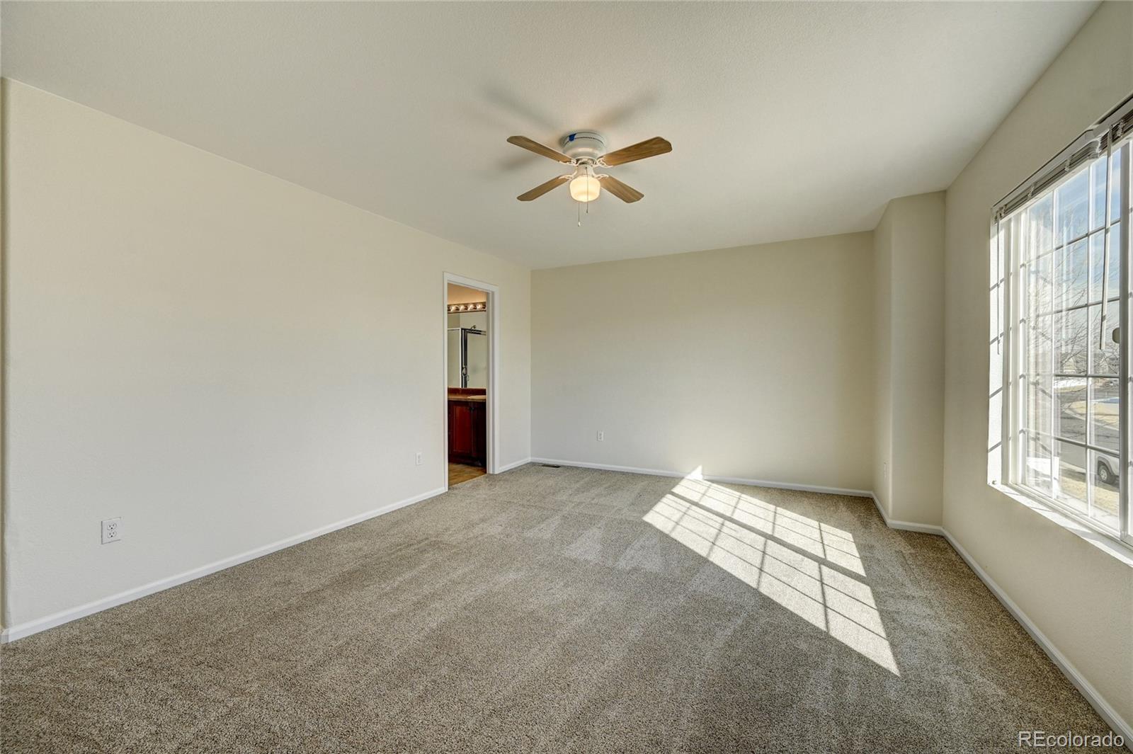 20527 Robins Drive Denver, CO 80249 - Photo 16 of 25 a view of an empty room with a window