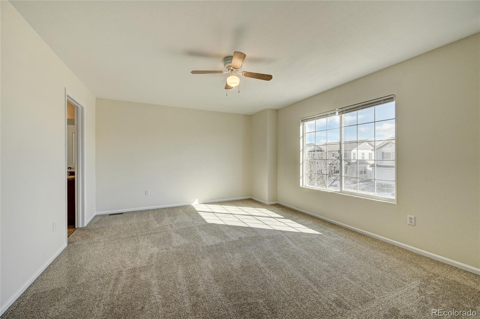 20527 Robins Drive Denver, CO 80249 - Photo 18 of 25 a view of an empty room with a window