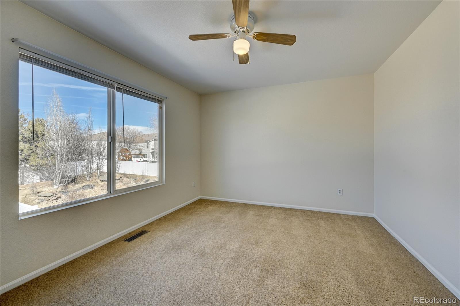 20527 Robins Drive Denver, CO 80249 - Photo 19 of 25 an empty room with a window