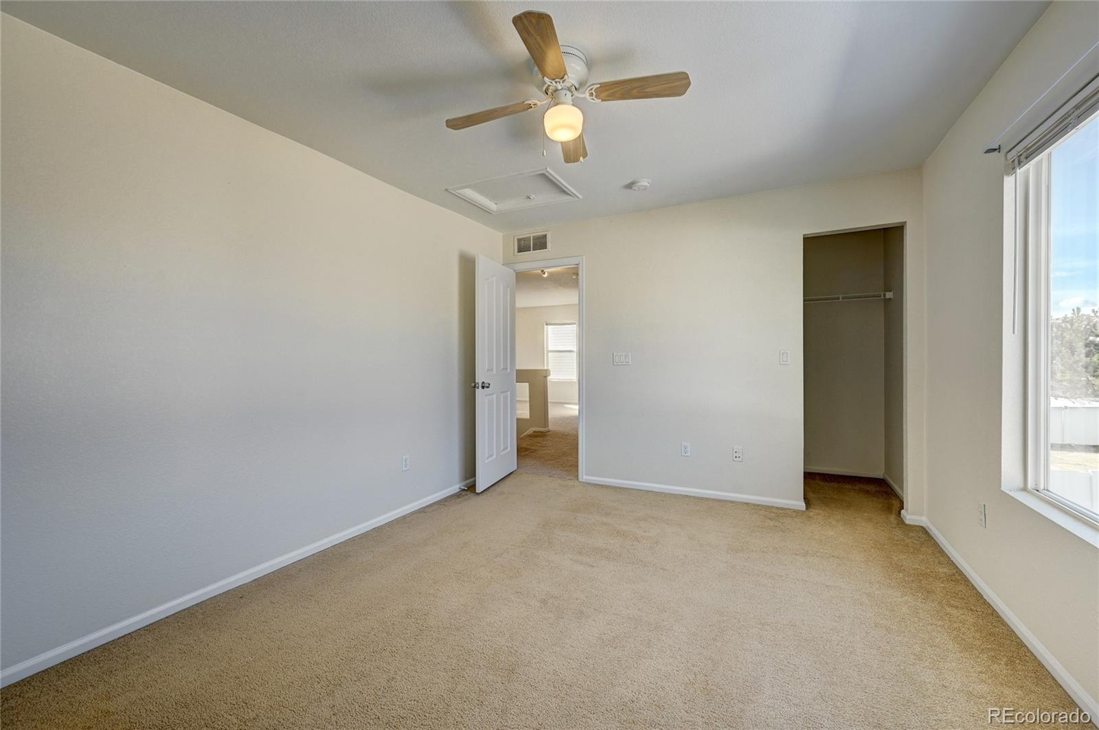 20527 Robins Drive Denver, CO 80249 - Photo 20 of 25 a view of an empty room with a window