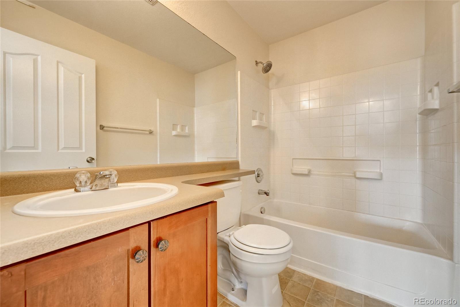 20527 Robins Drive Denver, CO 80249 - Photo 21 of 25 a bathroom with a sink a toilet and shower