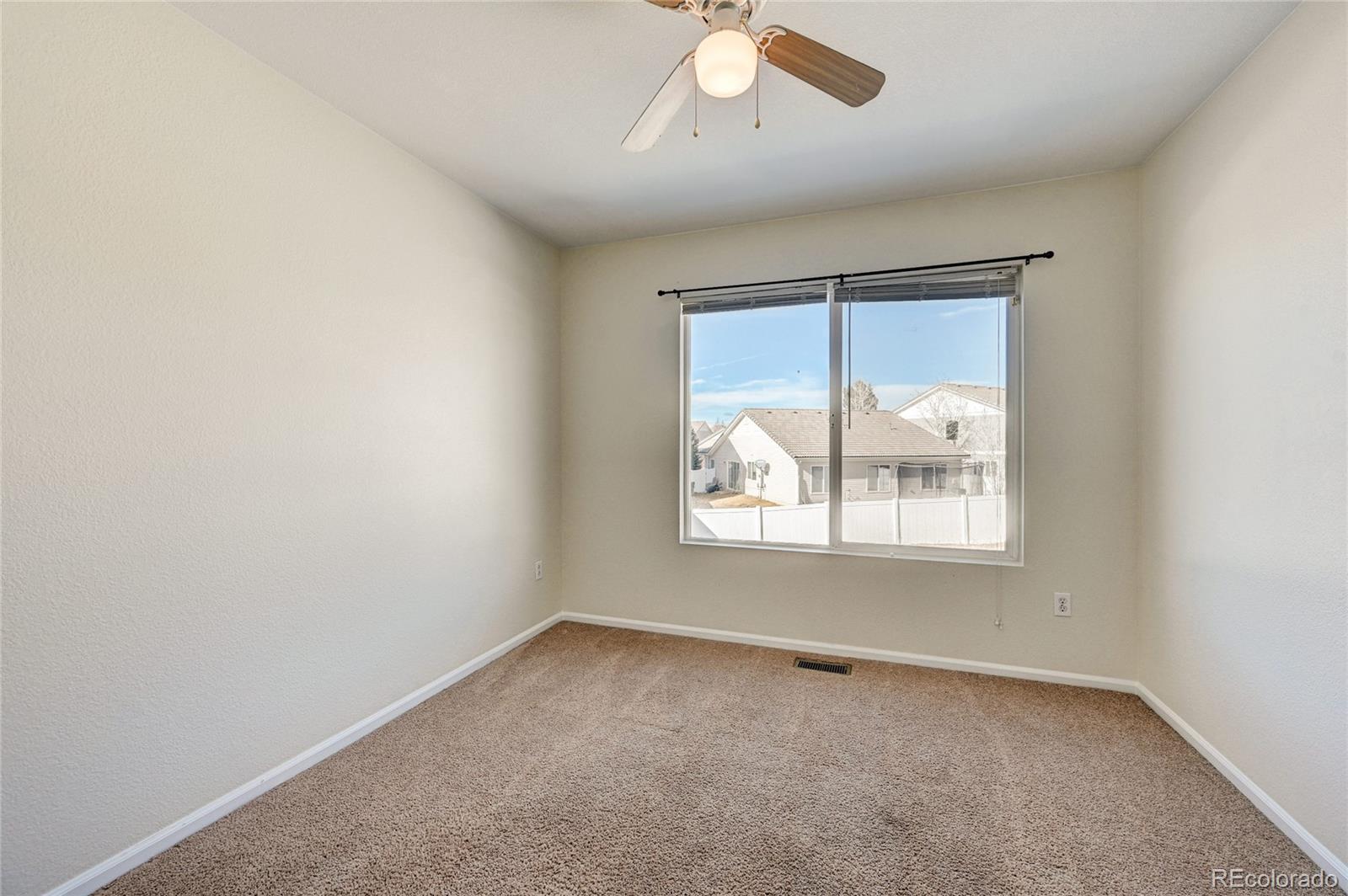 20527 Robins Drive Denver, CO 80249 - Photo 23 of 25 an empty room with a window
