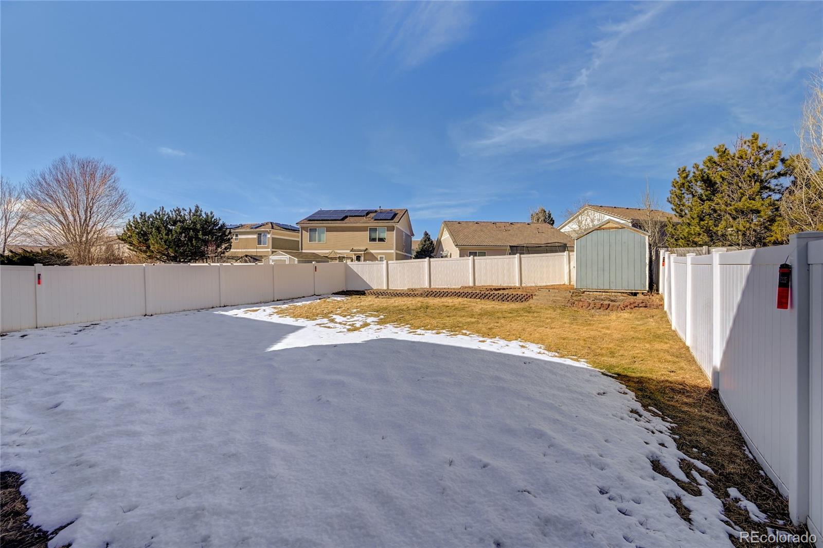 20527 Robins Drive Denver, CO 80249 - Photo 24 of 25 a view of a house with a yard