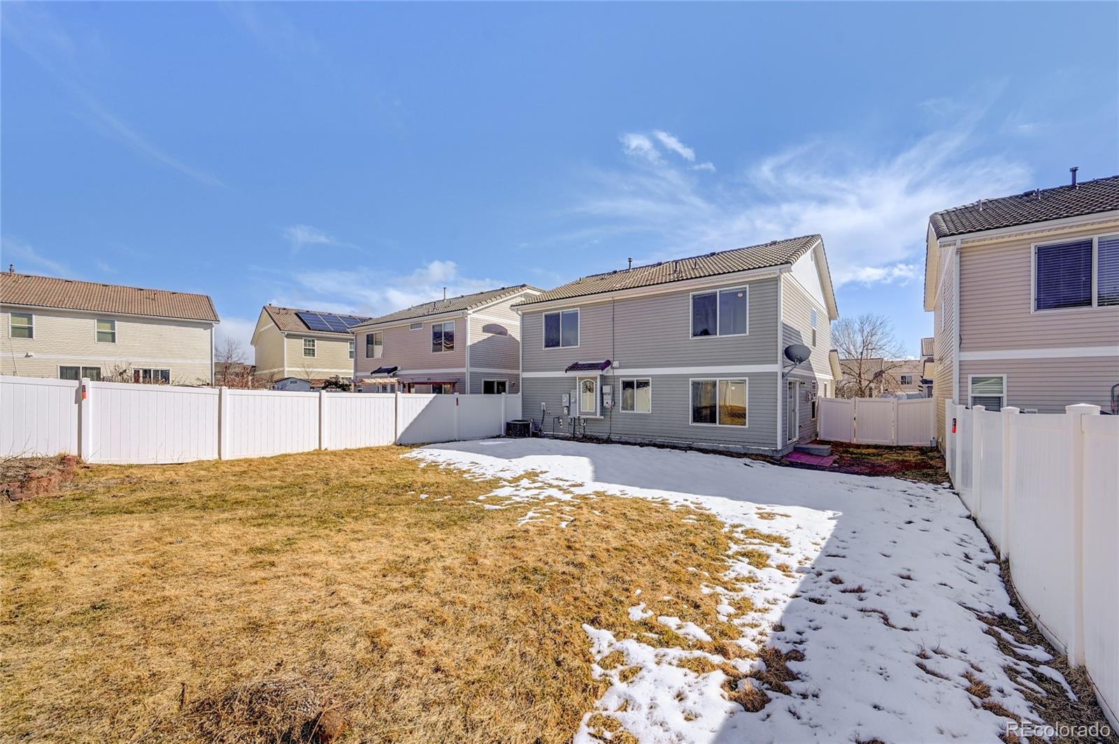 20527 Robins Drive Denver, CO 80249 - Photo 25 of 25 a view of a house with a snow in the yard