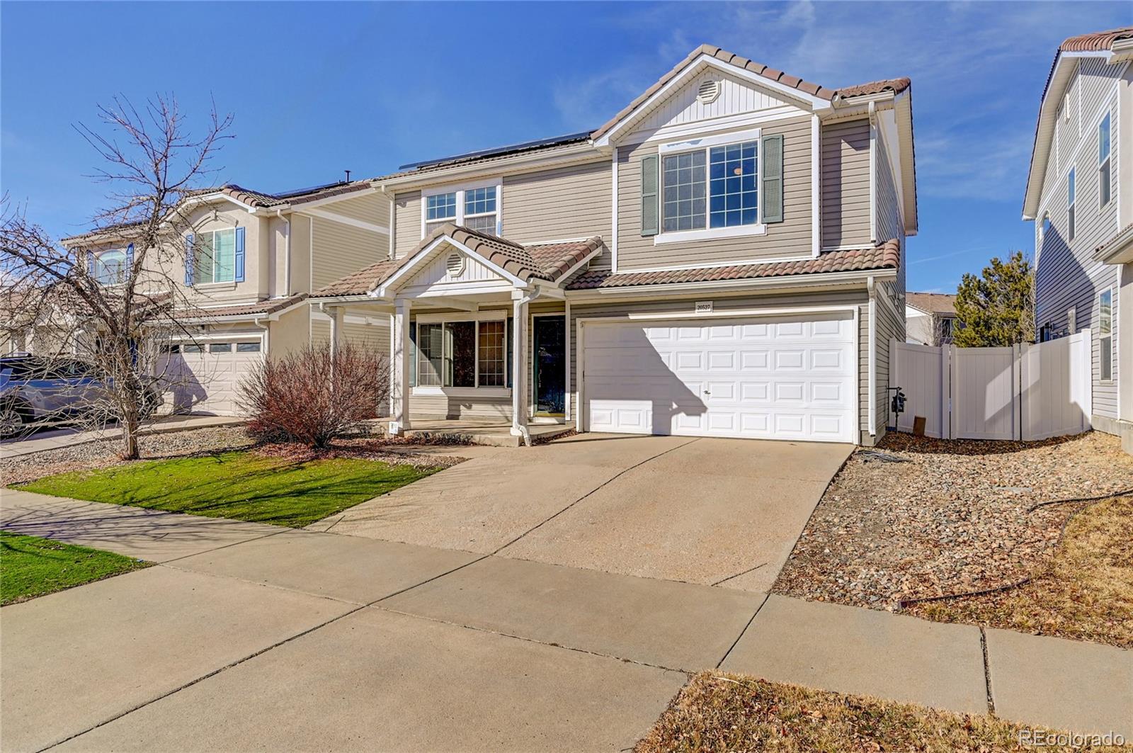 20527 Robins Drive Denver, CO 80249 - Photo 4 of 25 a front view of a house with garden