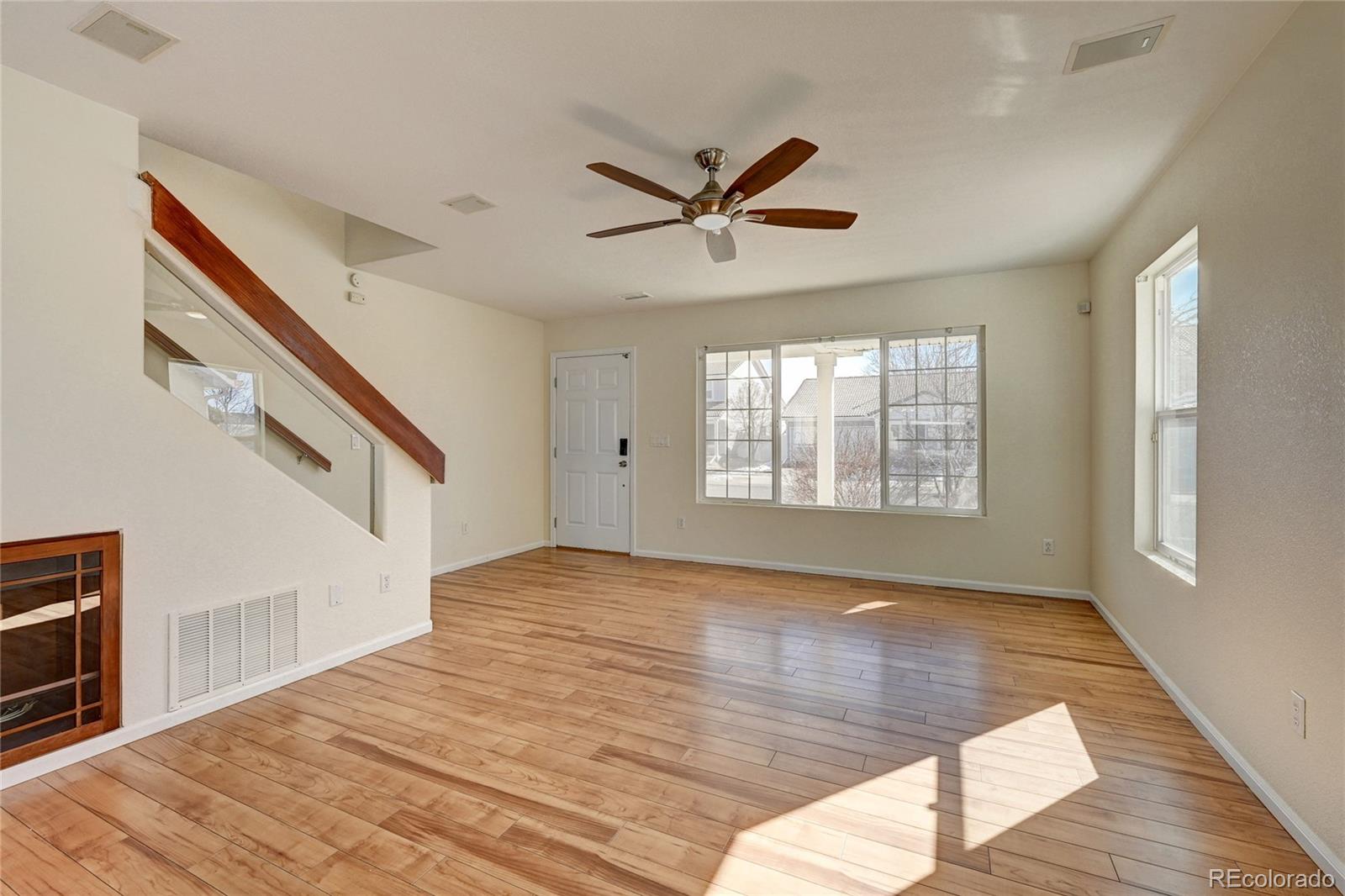 20527 Robins Drive Denver, CO 80249 - Photo 5 of 25 a view of an empty room with wooden floor and a window